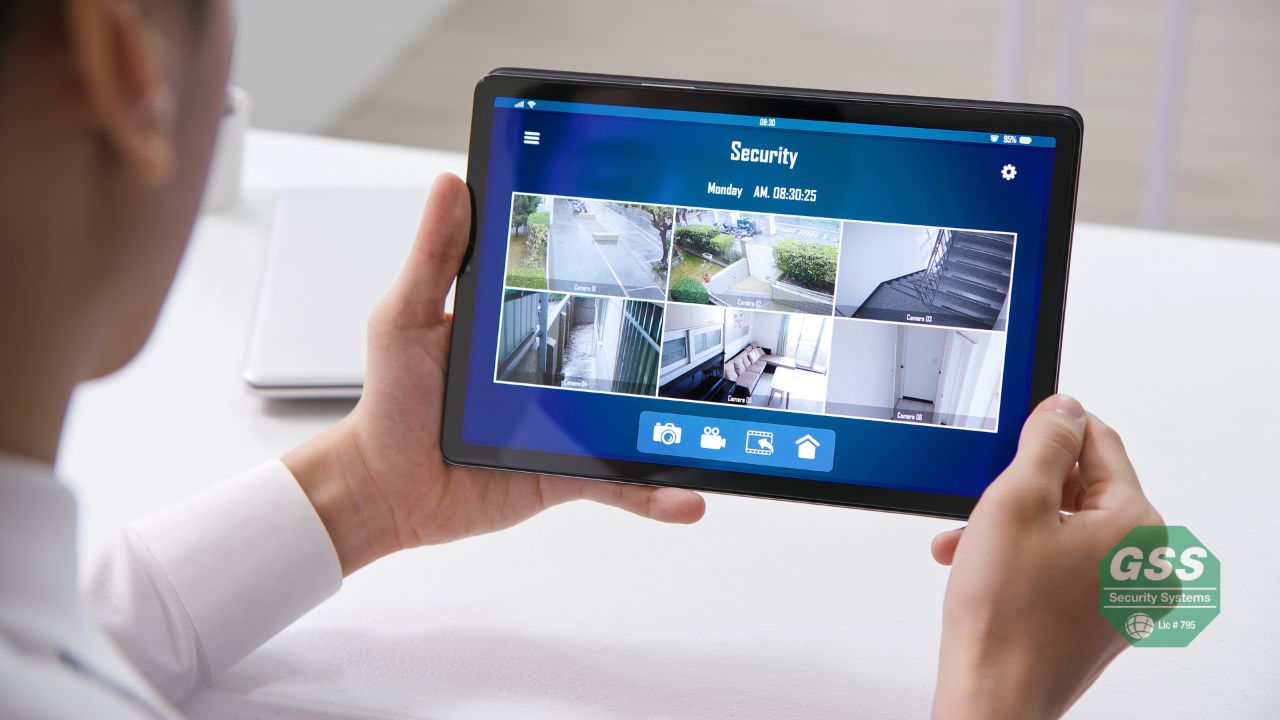 Father viewing his home surveillance footage on a tablet, feeling secure and connected.