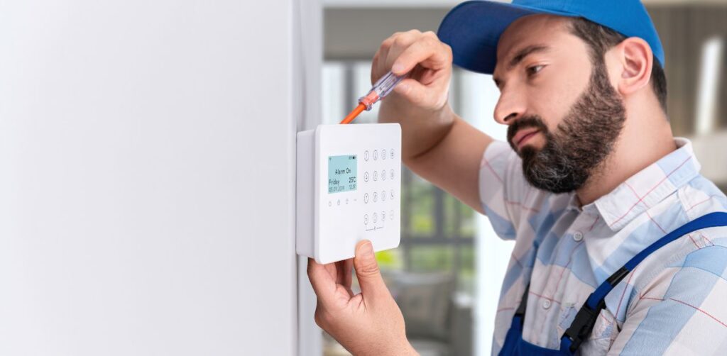 A close-up of a burglar alarm keypad with red lights indicating activation