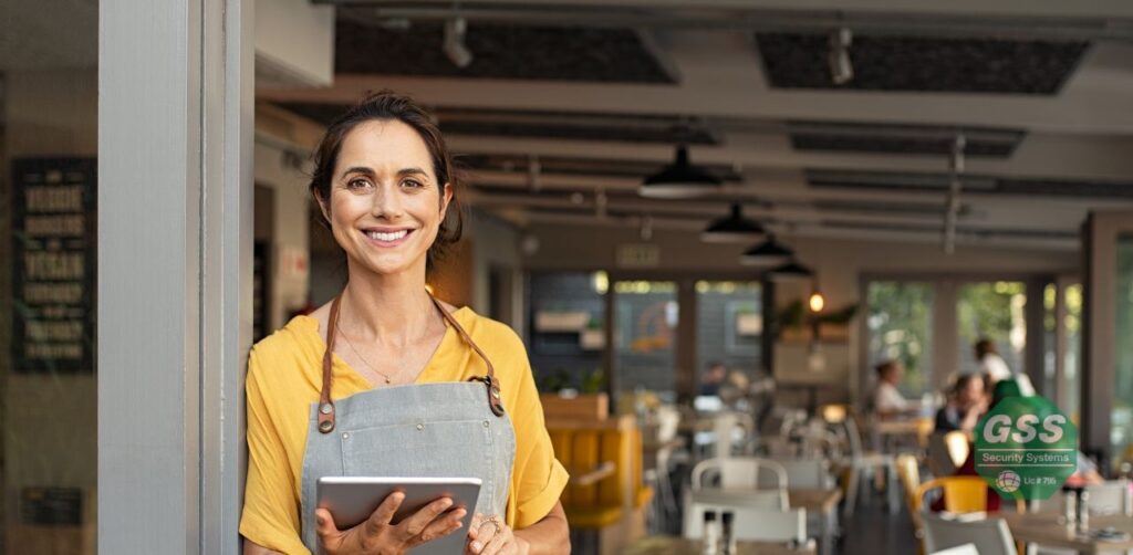 Entrepreneur accessing their business security remotely via a smart device.
