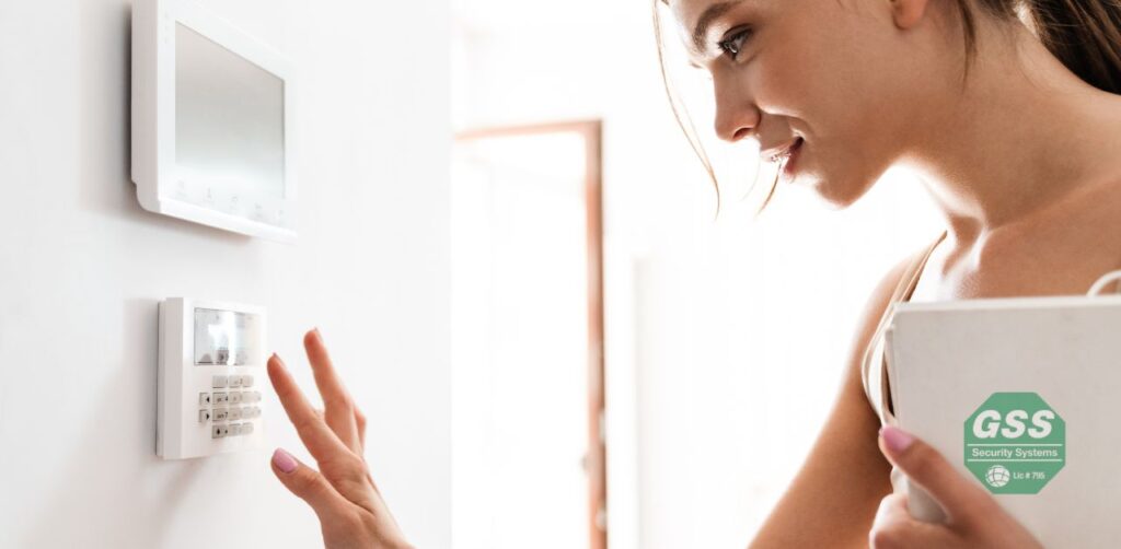 User interacting with a touch screen panel of a no-contract security system.