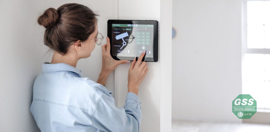 A person installing a DIY no-contract alarm system.