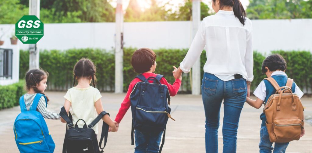 A happy family walking together with backpacks, symbolizing back to school safety.