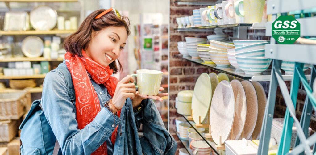 Busy retail store with visible security measures during the holiday season.