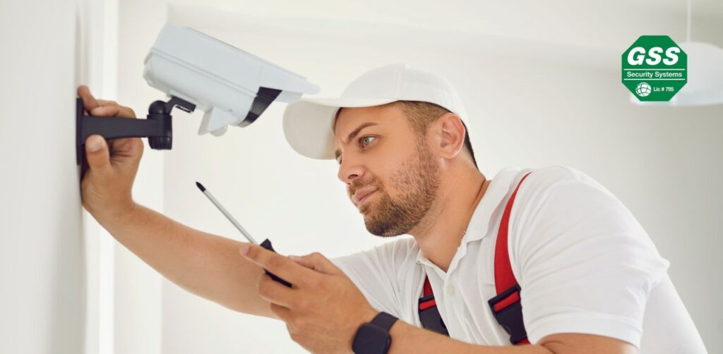 Professionals installing a commercial security system in a business environment.