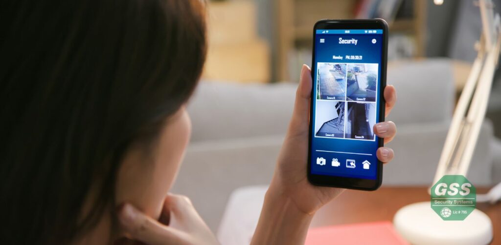 A person using a smartphone to access a security camera feed