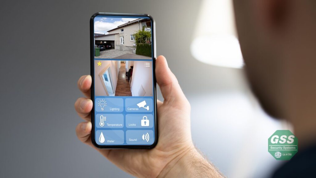 A person using a smartphone to manage their home security system remotely.