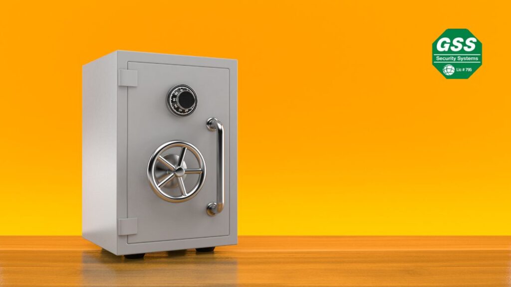 A secure metal safe with a combination lock and handle, placed on a wooden surface against a vibrant orange background, representing safety and protection of valuables.
